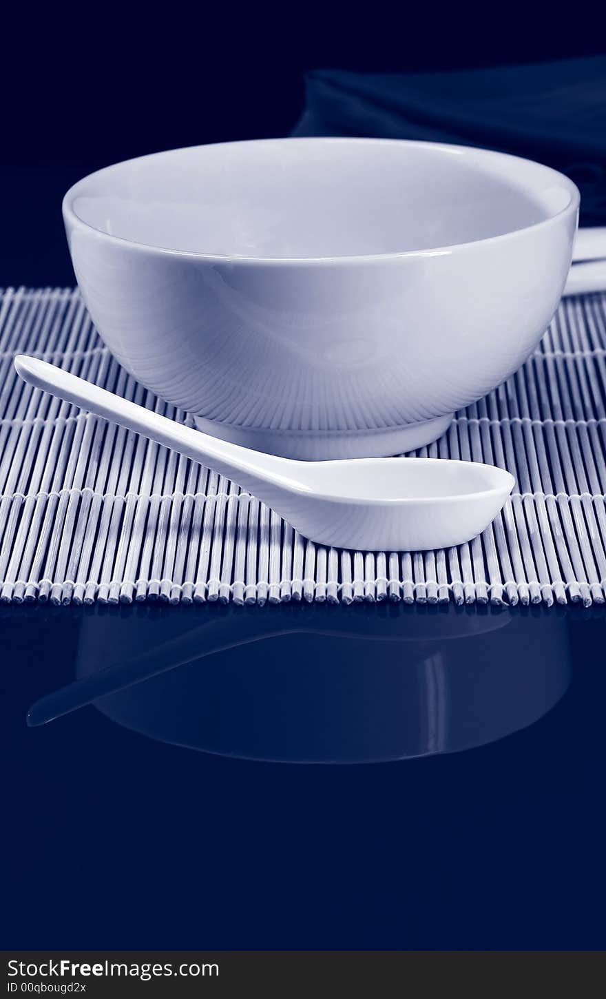 A table set for lunch with soup bowl and spoon. A table set for lunch with soup bowl and spoon