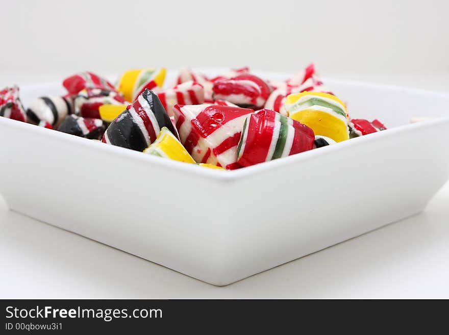 A bowl full of hard candy, very colorful and saturated colors. A bowl full of hard candy, very colorful and saturated colors