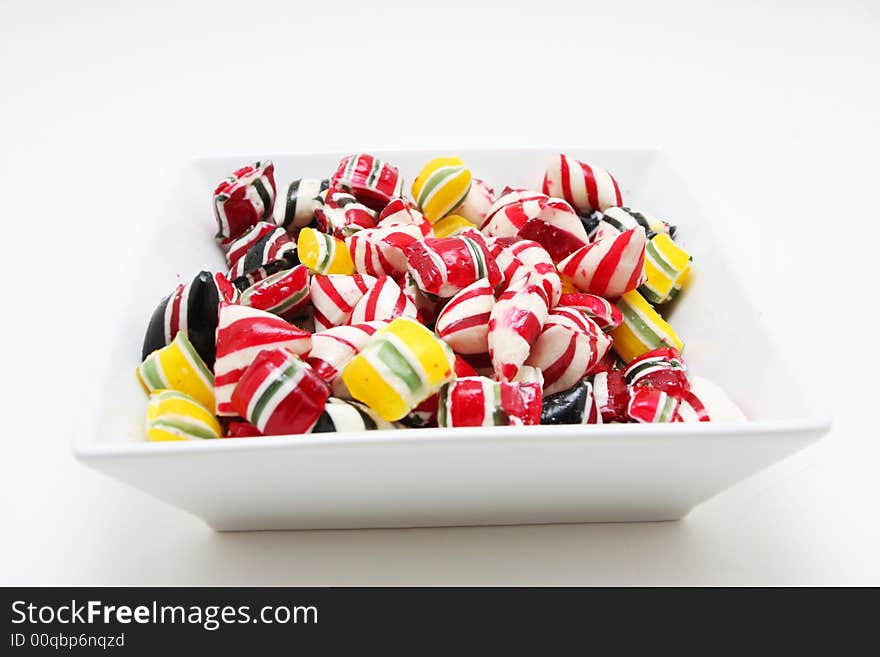 A bowl of hard peppermint candies. A bowl of hard peppermint candies