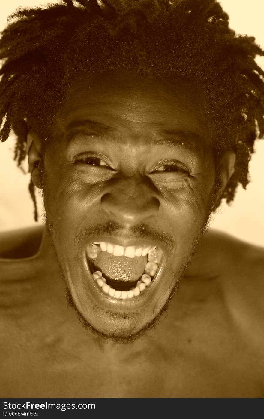 Portrait of an african young man expressing anger in sepia. Portrait of an african young man expressing anger in sepia.