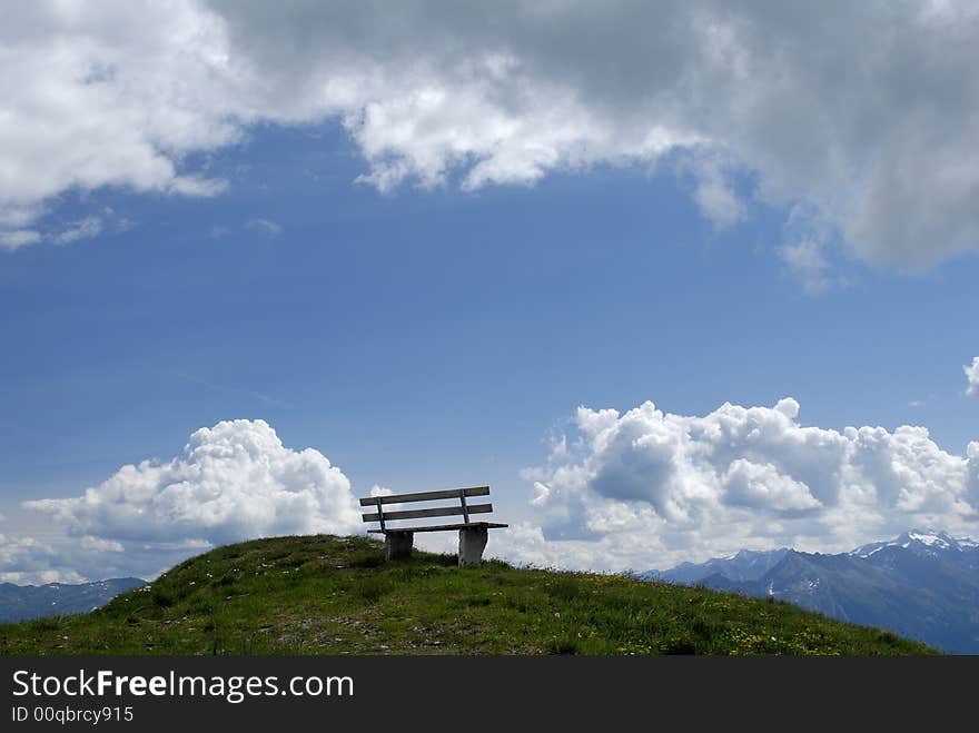 Empty bench on alpine mountain