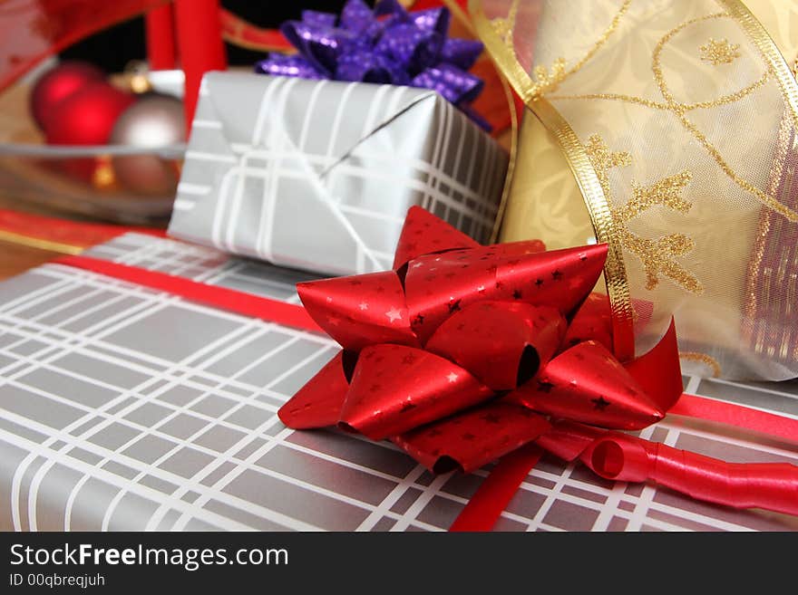 Christmas present on a solid oak table, ribbons and decorations around. Christmas present on a solid oak table, ribbons and decorations around