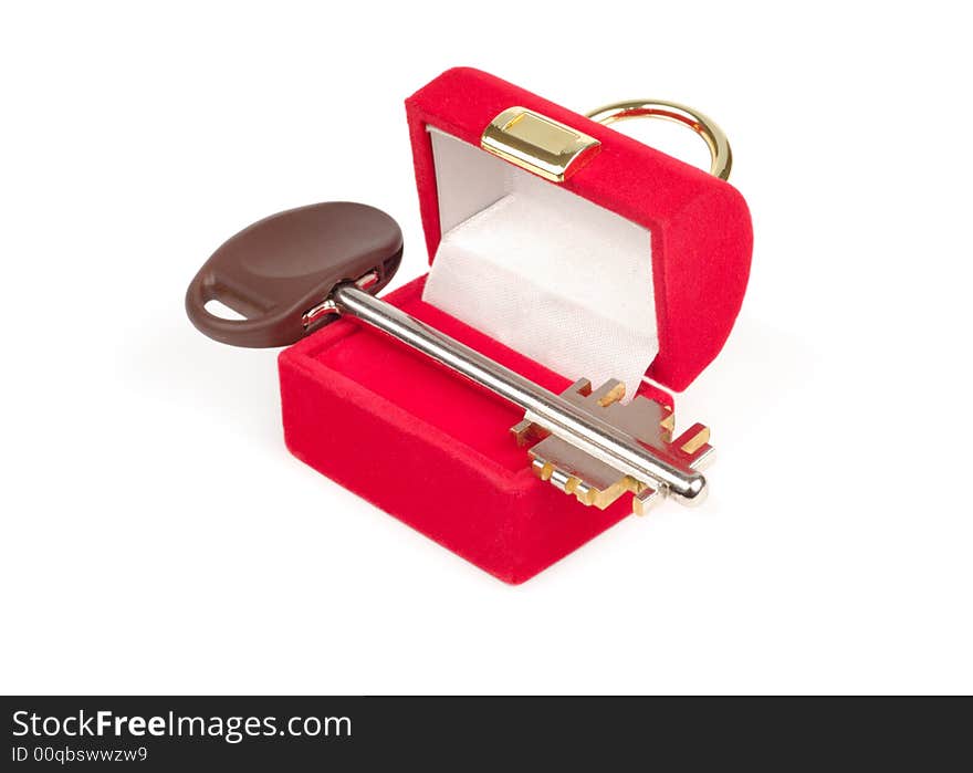 Red present box with steel key isolated over white. Red present box with steel key isolated over white