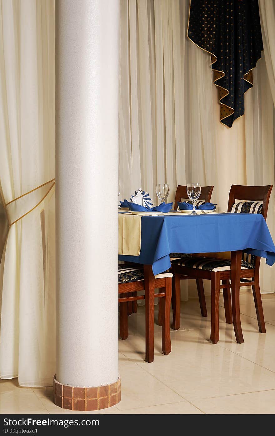 Table with a blue tablecloth at fashionable and modern restaurant
