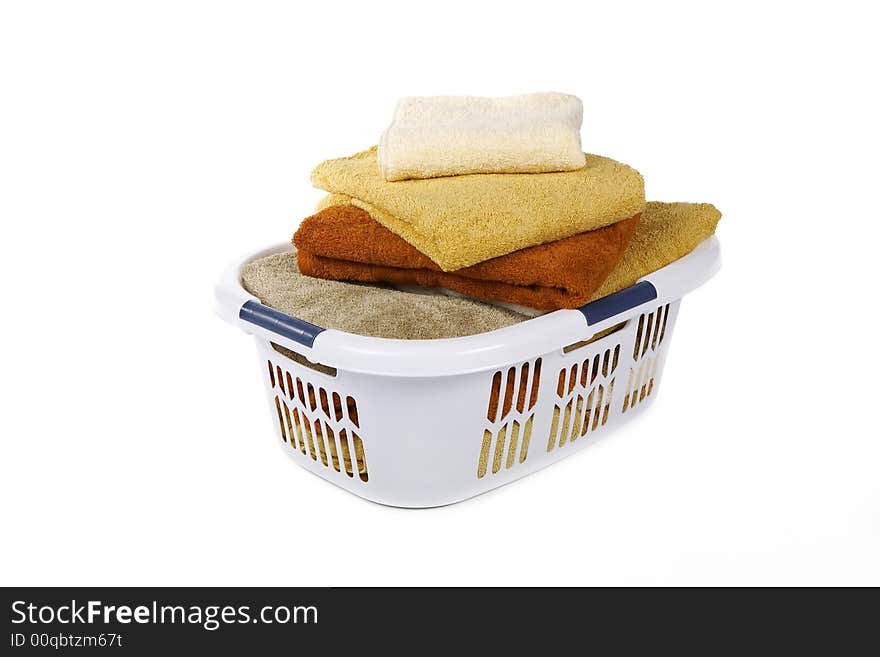 White Basket of clean colorful towels. White Basket of clean colorful towels