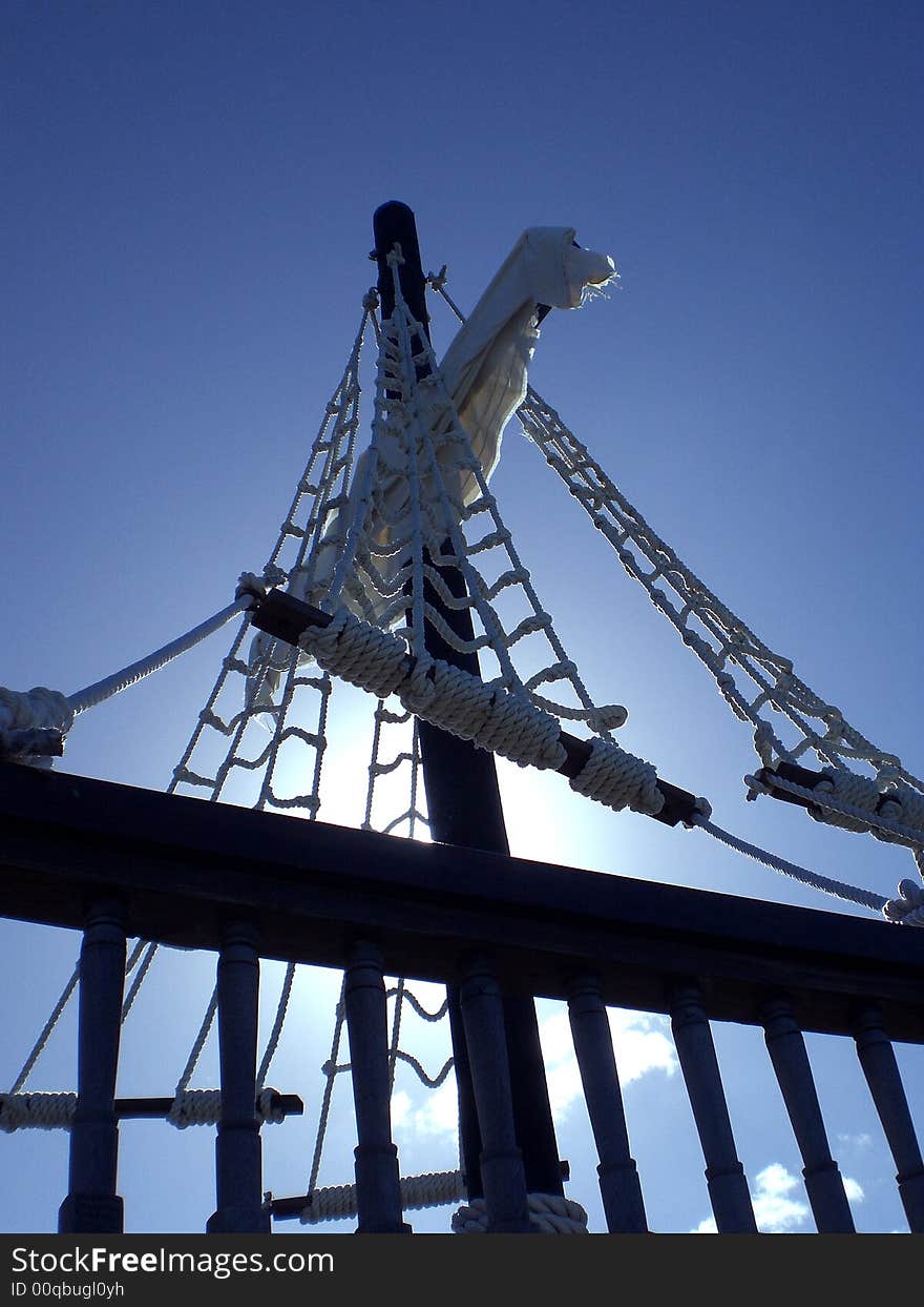 Mast and rigging of a playground pirate ship against blue sky, many different ways to reach the sky, the sky is the limit. Mast and rigging of a playground pirate ship against blue sky, many different ways to reach the sky, the sky is the limit