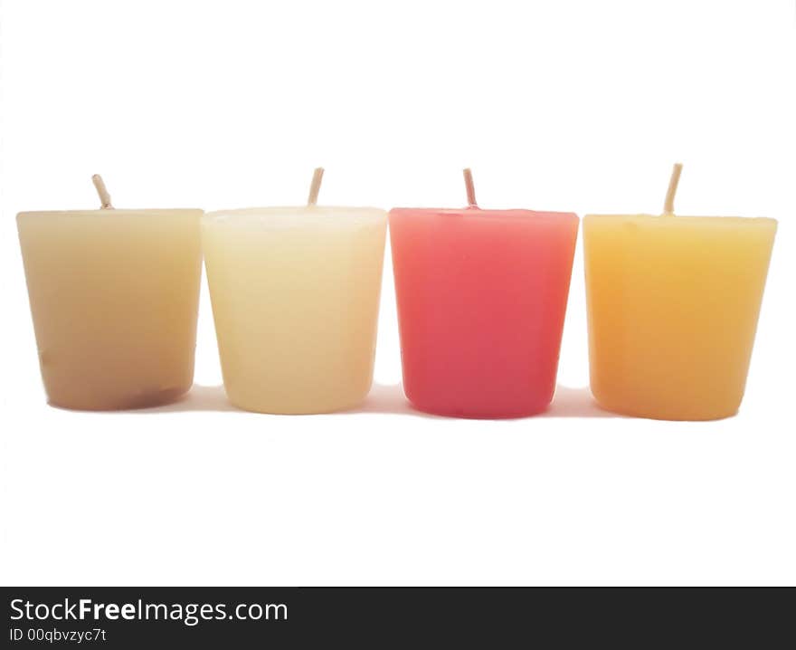 Four different colored candles over a white background. Four different colored candles over a white background