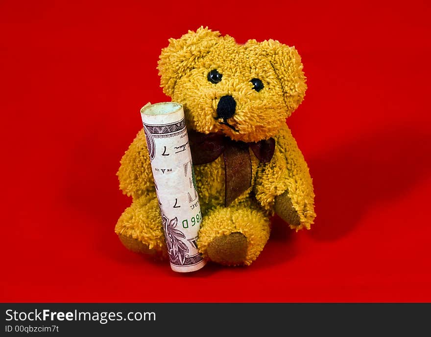 Teddy bear carrying Dollar Bill