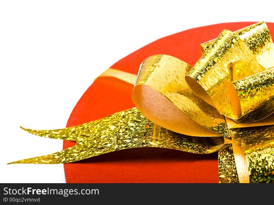 Closeup red present box with gold bow. Closeup red present box with gold bow