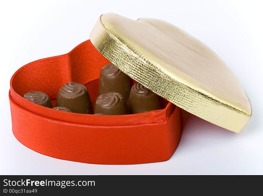 Red box with chocolate candies and gold cover. Red box with chocolate candies and gold cover