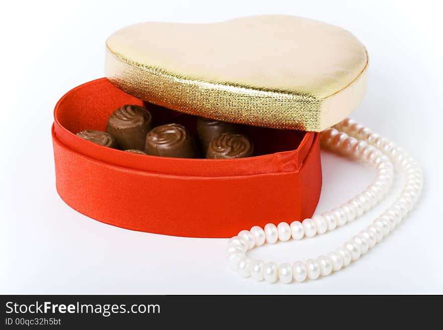 Red box with chocolate and pearl necklace