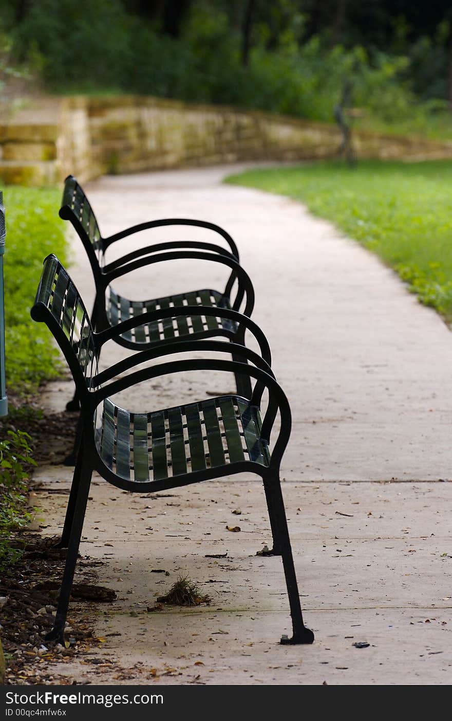 A pair of empty benches in the park