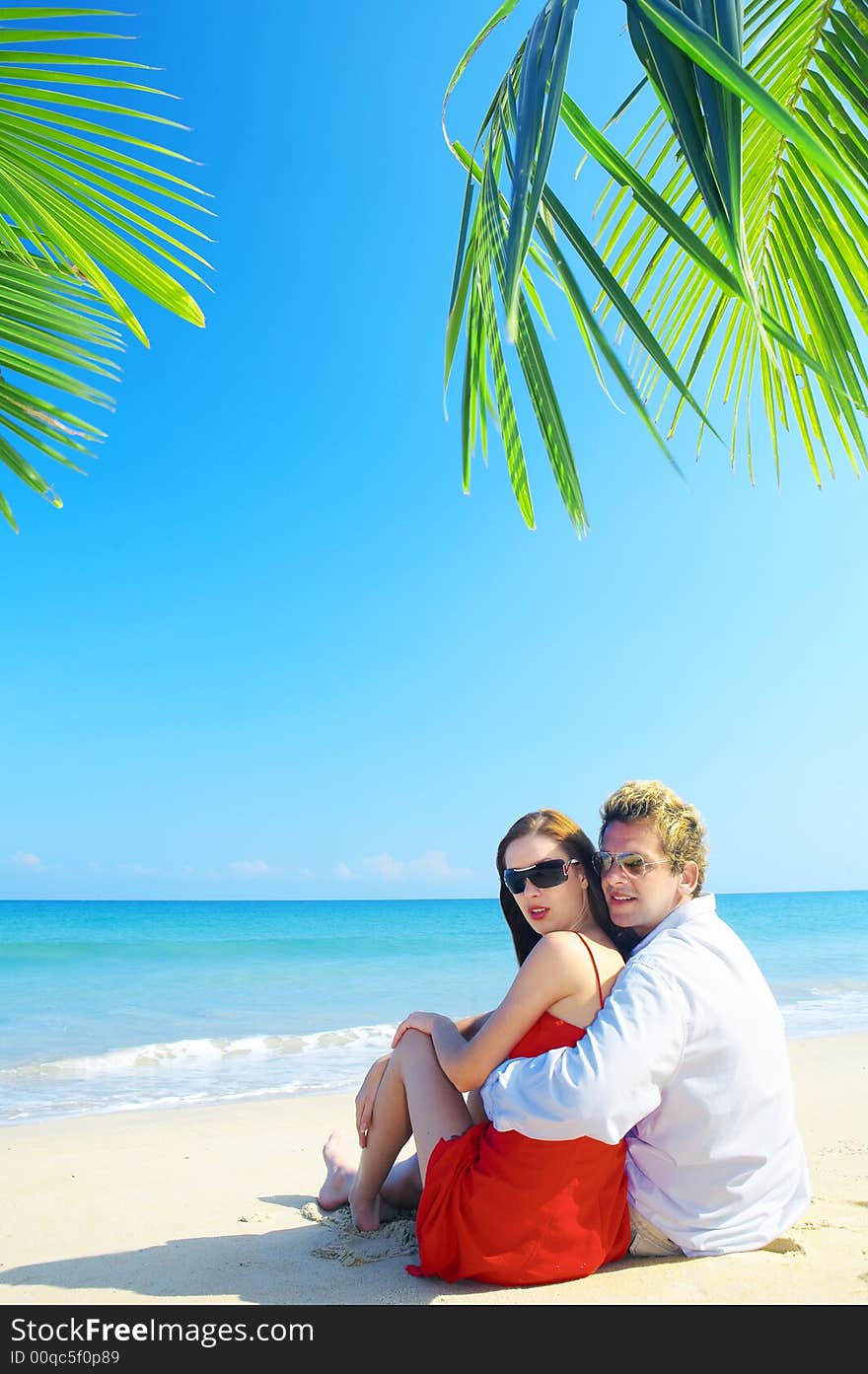 A portrait of attractive couple having date on the beach. A portrait of attractive couple having date on the beach