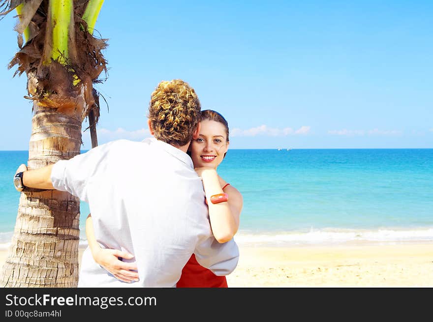 A portrait of attractive couple having date on the beach. A portrait of attractive couple having date on the beach