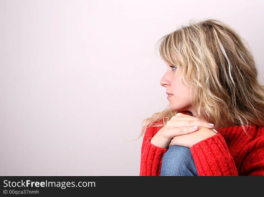 Blond Female model on a white background wearing a blue top. Blond Female model on a white background wearing a blue top