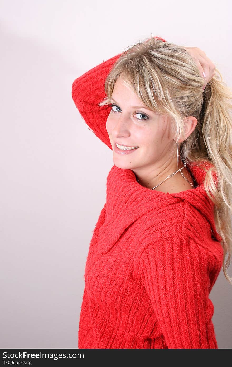 Blond Female model on a white background wearing a blue top. Blond Female model on a white background wearing a blue top