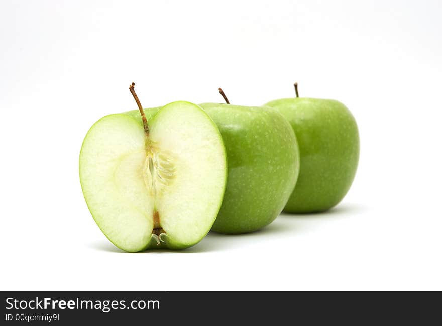 Fresh green apples with half isolated on white