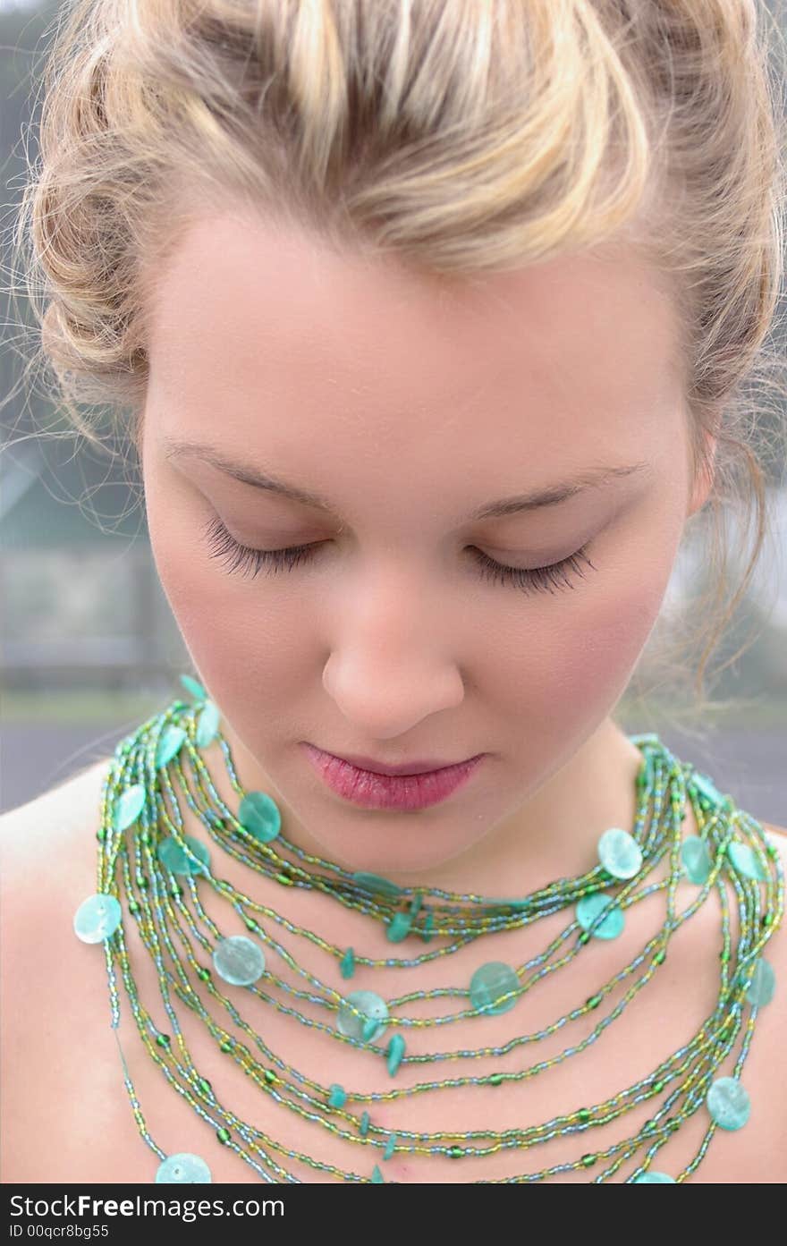 Beautiful Girl wearing a green necklace. Beautiful Girl wearing a green necklace