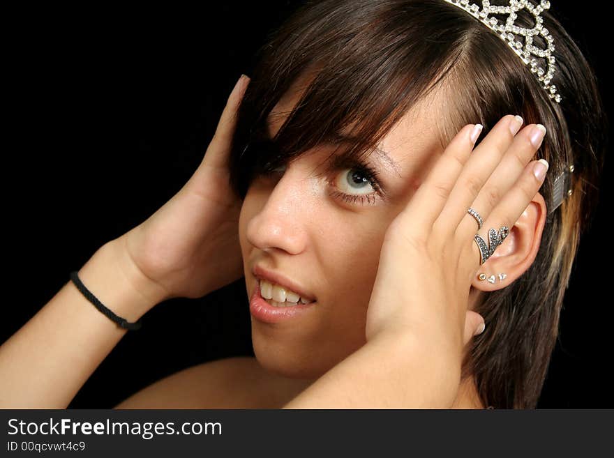 Girl with a diadem, isolated on black