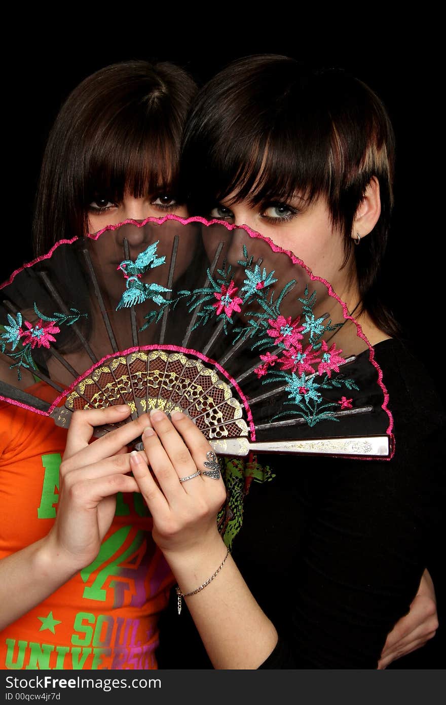 Girls with a spanish fan, on black background