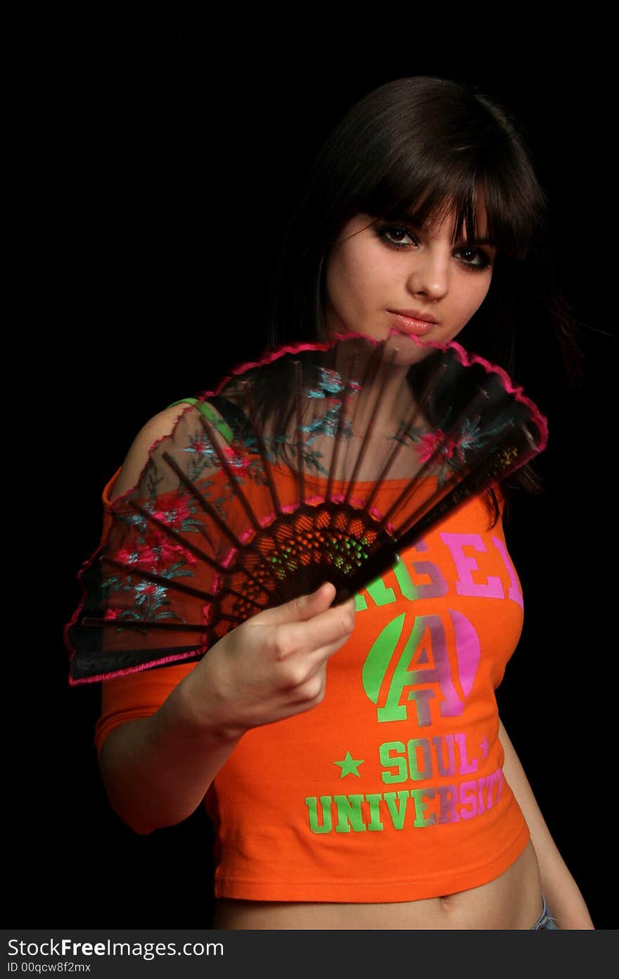 Girl with a spanish fan, on black background