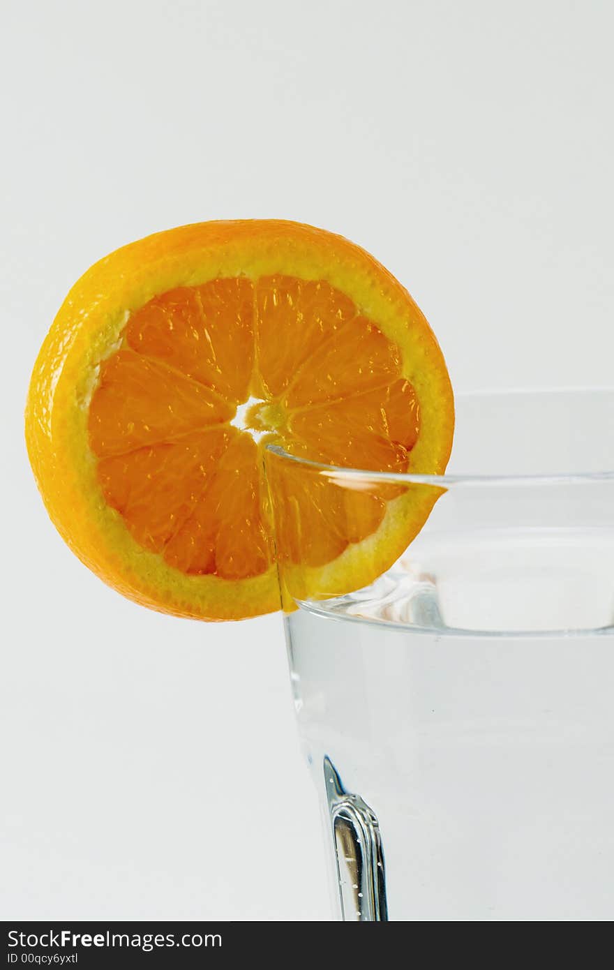 Orange slice on glass of water isolated. Orange slice on glass of water isolated