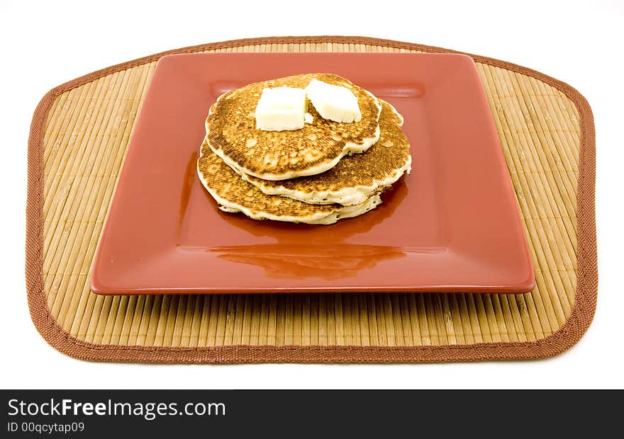 Plate of pancakes and butter isolated on white background. Plate of pancakes and butter isolated on white background.