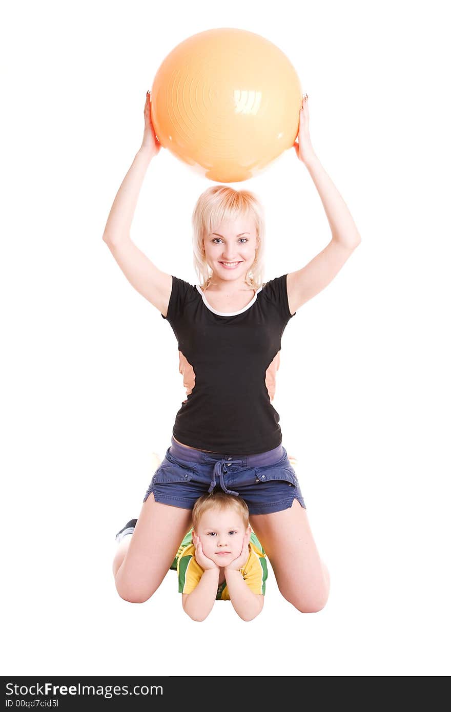 Smiling happy young mother and her son with a fitness ball on the floor. Smiling happy young mother and her son with a fitness ball on the floor