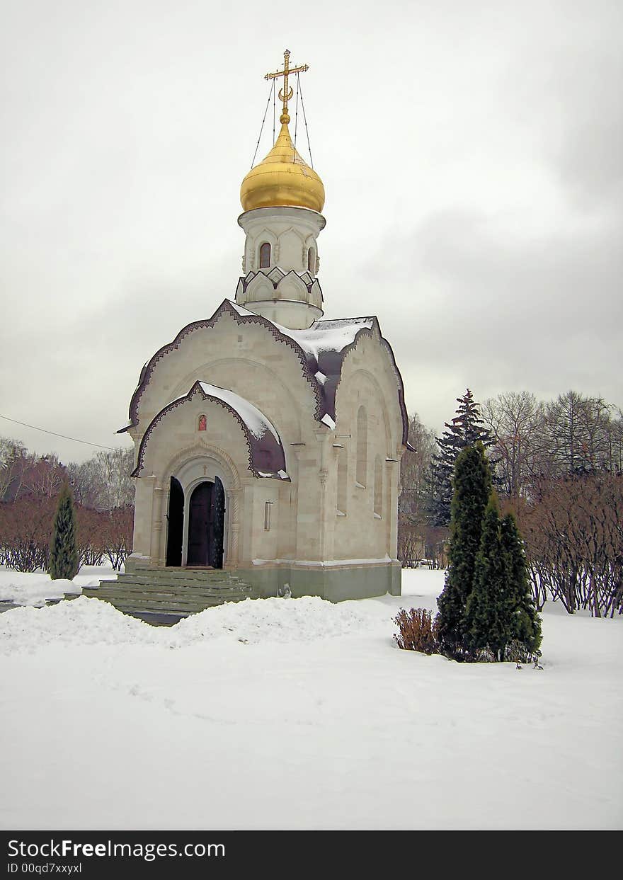 Orthodox chapel in the winter on a background of trees and snows.