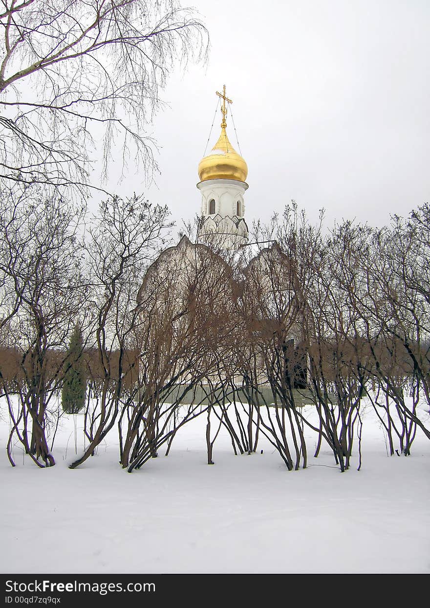 Orthodox chapel in the winter on a background of trees and snows.