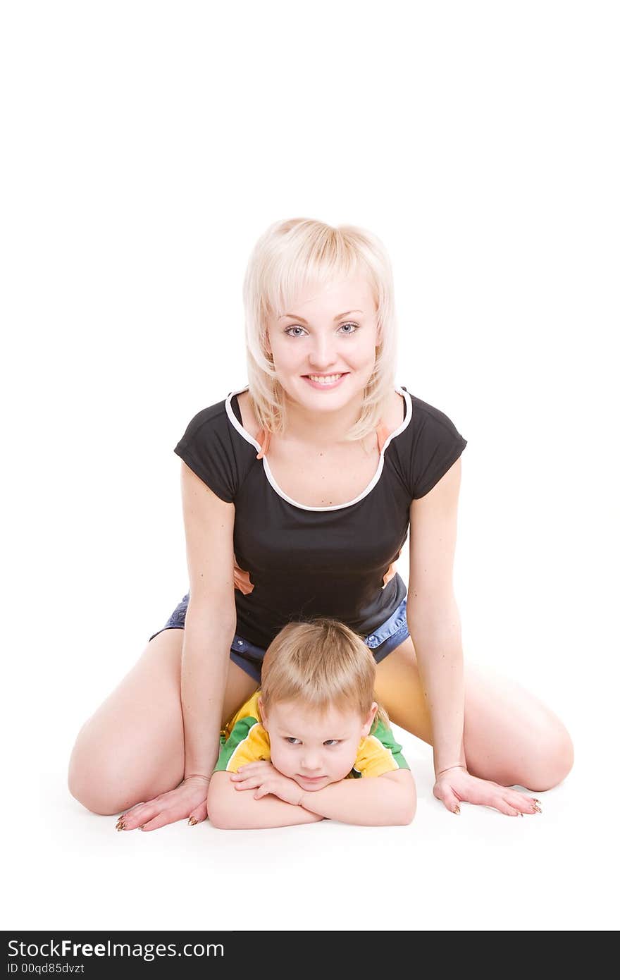 Smiling happy young mother and her little son on the floor