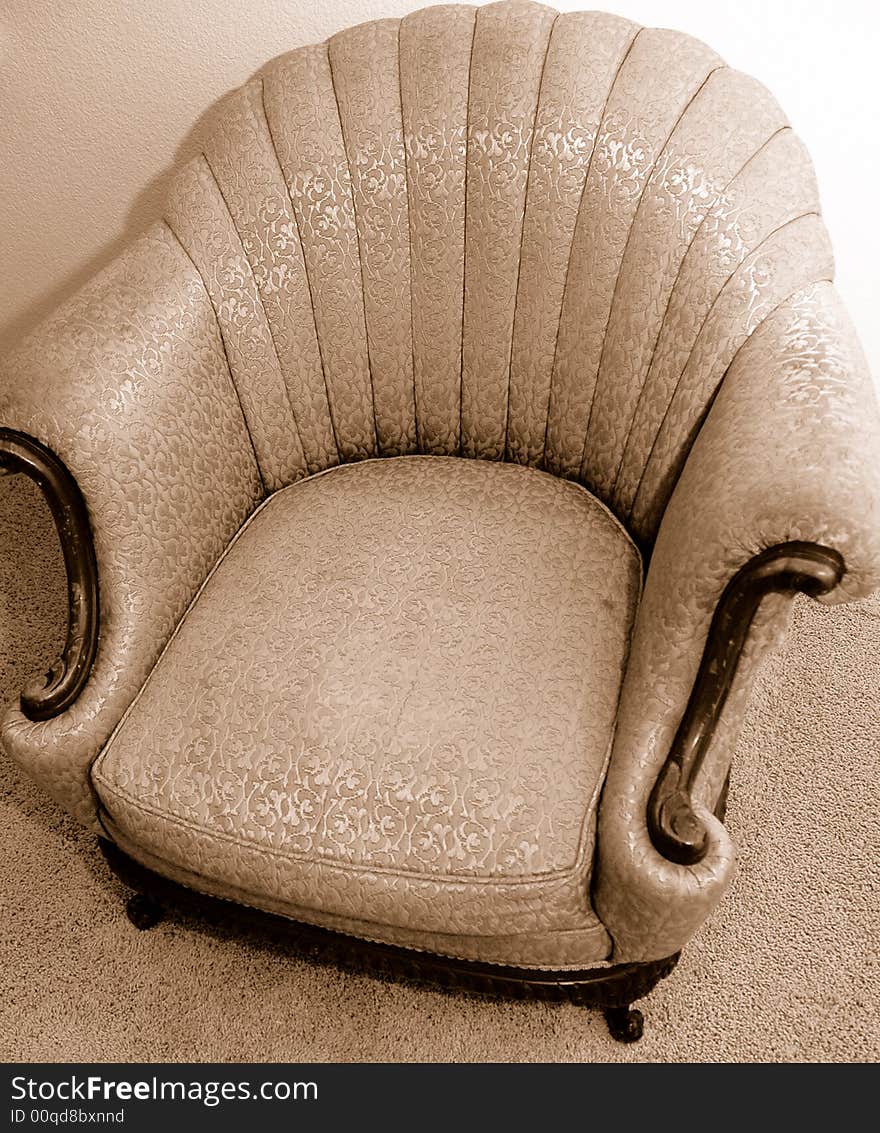 Antique Chair with brown woodend accents and fabric detail