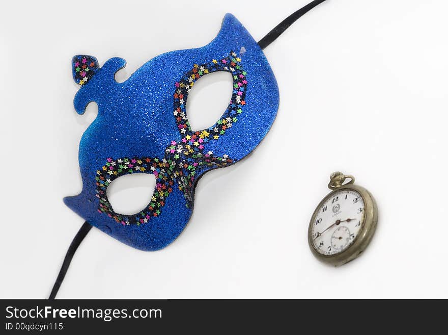 Blue carnival mask and clock