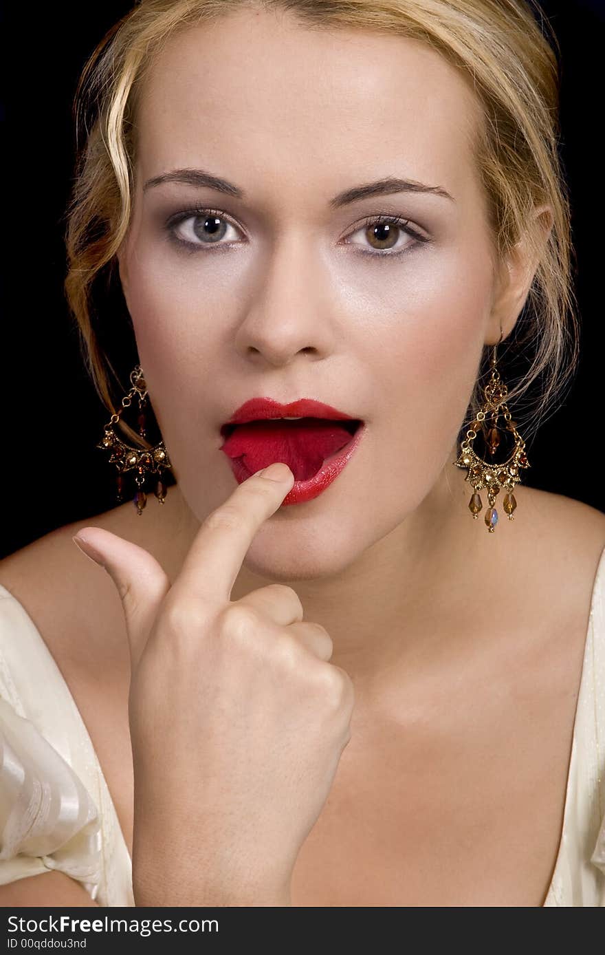 Beautiful blond girl kissing and smelling a rose petal wearing dress. Beautiful blond girl kissing and smelling a rose petal wearing dress