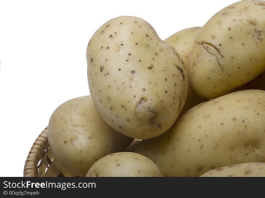 Potatoes on the wicker basket on the white backgrounds