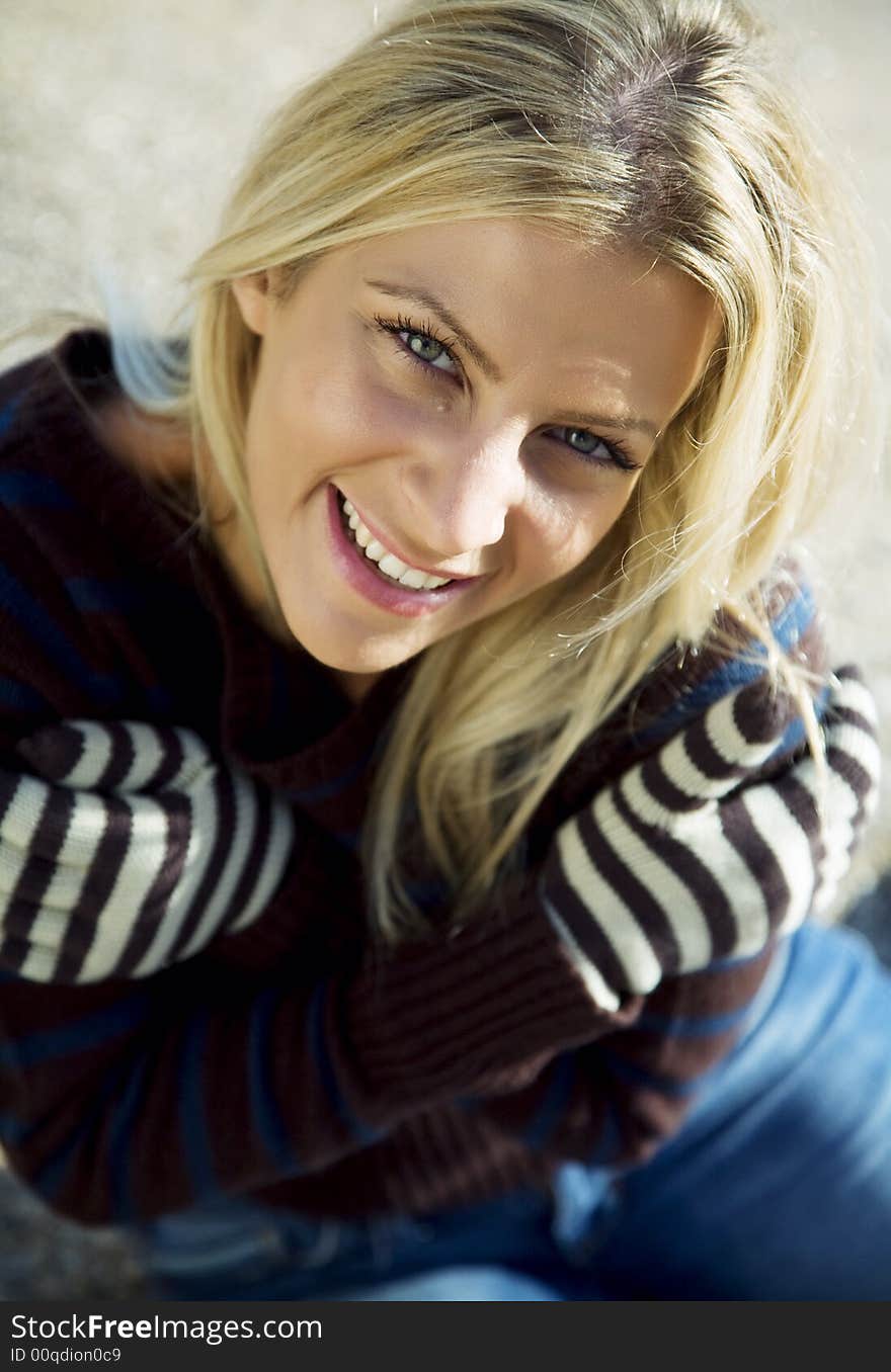 Young, pretty blond woman smiling.