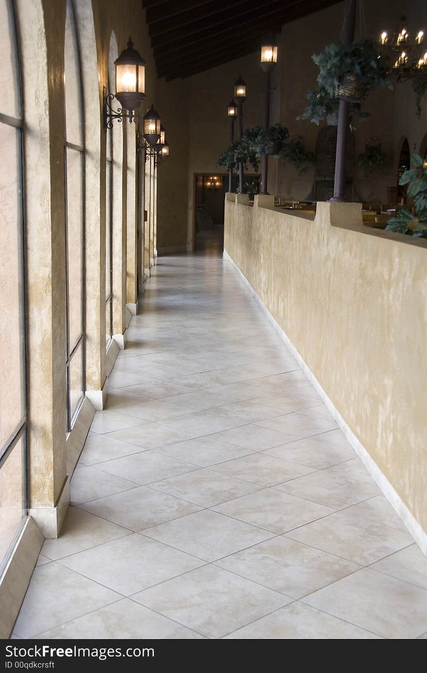 A natural light lit hallway with marble floor. A natural light lit hallway with marble floor