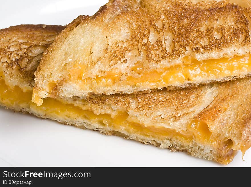 Grilled cheese sandwich on a white plate shot with a macro lens. Grilled cheese sandwich on a white plate shot with a macro lens