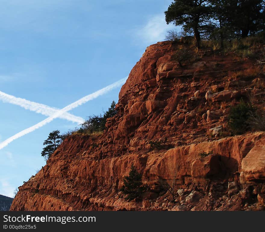 X Marks the Spot ! V2 A picture of two plane trails in the sky next to a beautiful piece of Colorado landscape.