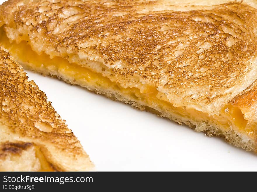 Grilled cheese sandwich on a white plate shot with a macro lens. Grilled cheese sandwich on a white plate shot with a macro lens