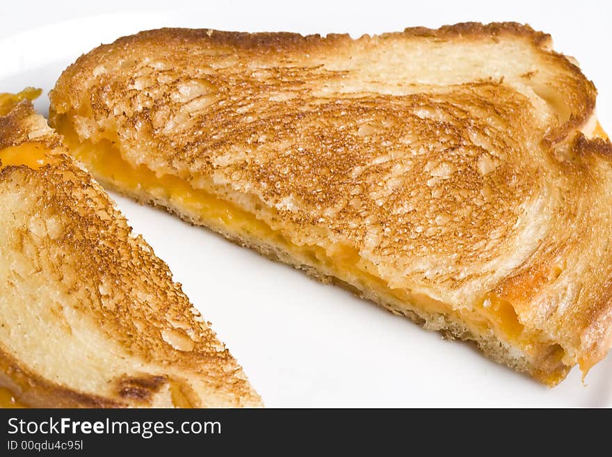 Grilled cheese sandwich on a white plate shot with a macro lens. Grilled cheese sandwich on a white plate shot with a macro lens