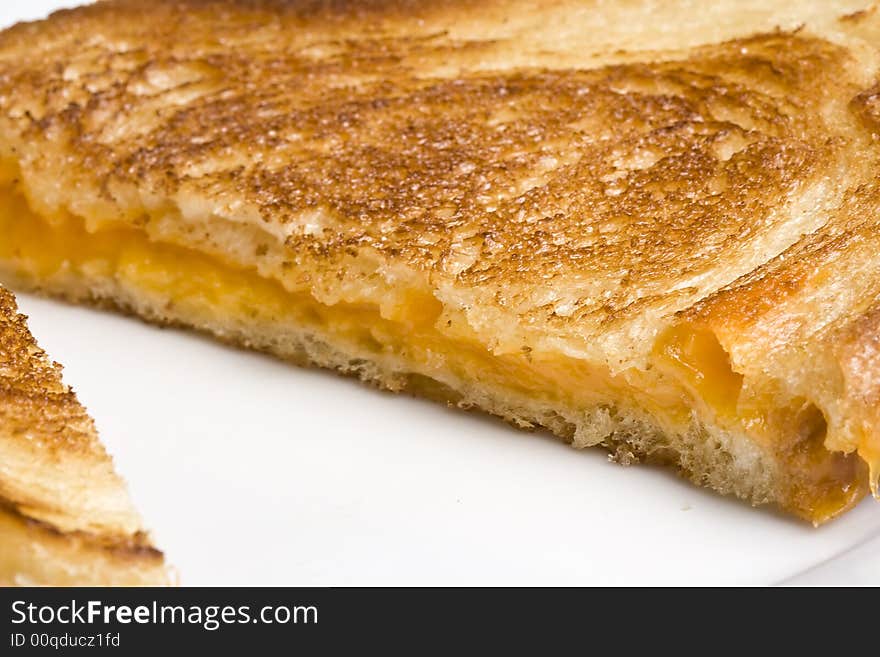 Grilled cheese sandwich on a white plate shot with a macro lens. Grilled cheese sandwich on a white plate shot with a macro lens