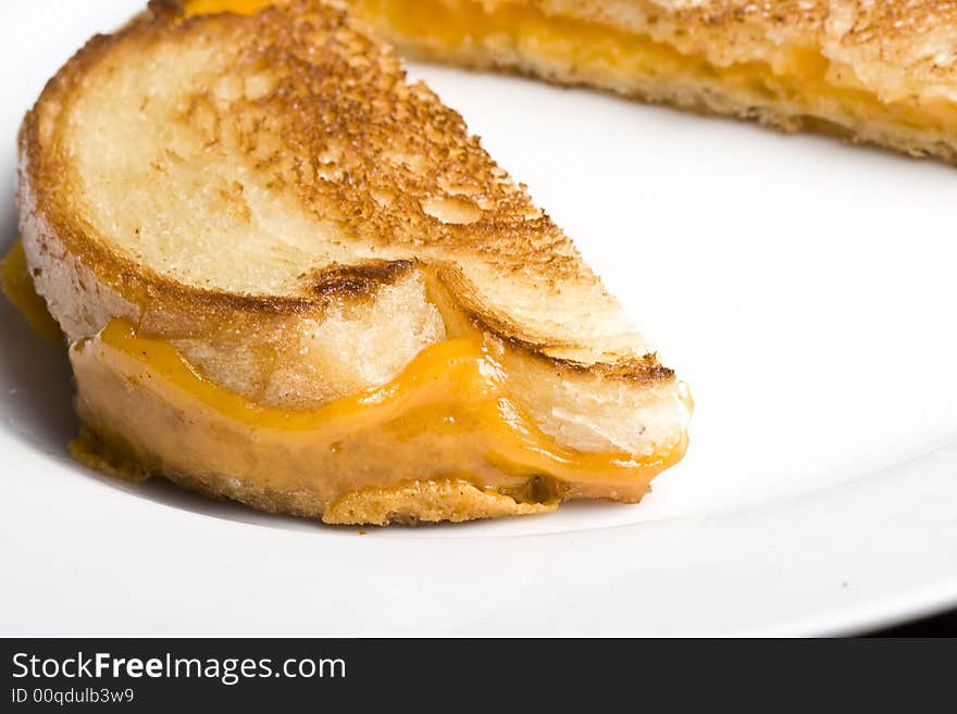 Grilled cheese sandwich on a white plate shot with a macro lens. Grilled cheese sandwich on a white plate shot with a macro lens