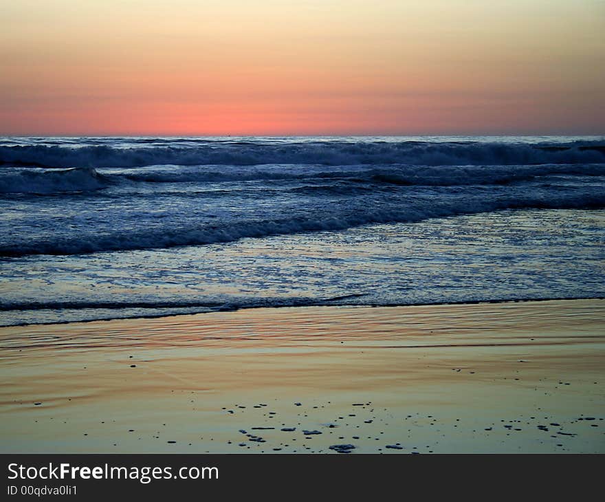 Ocean waves at colorful sunset