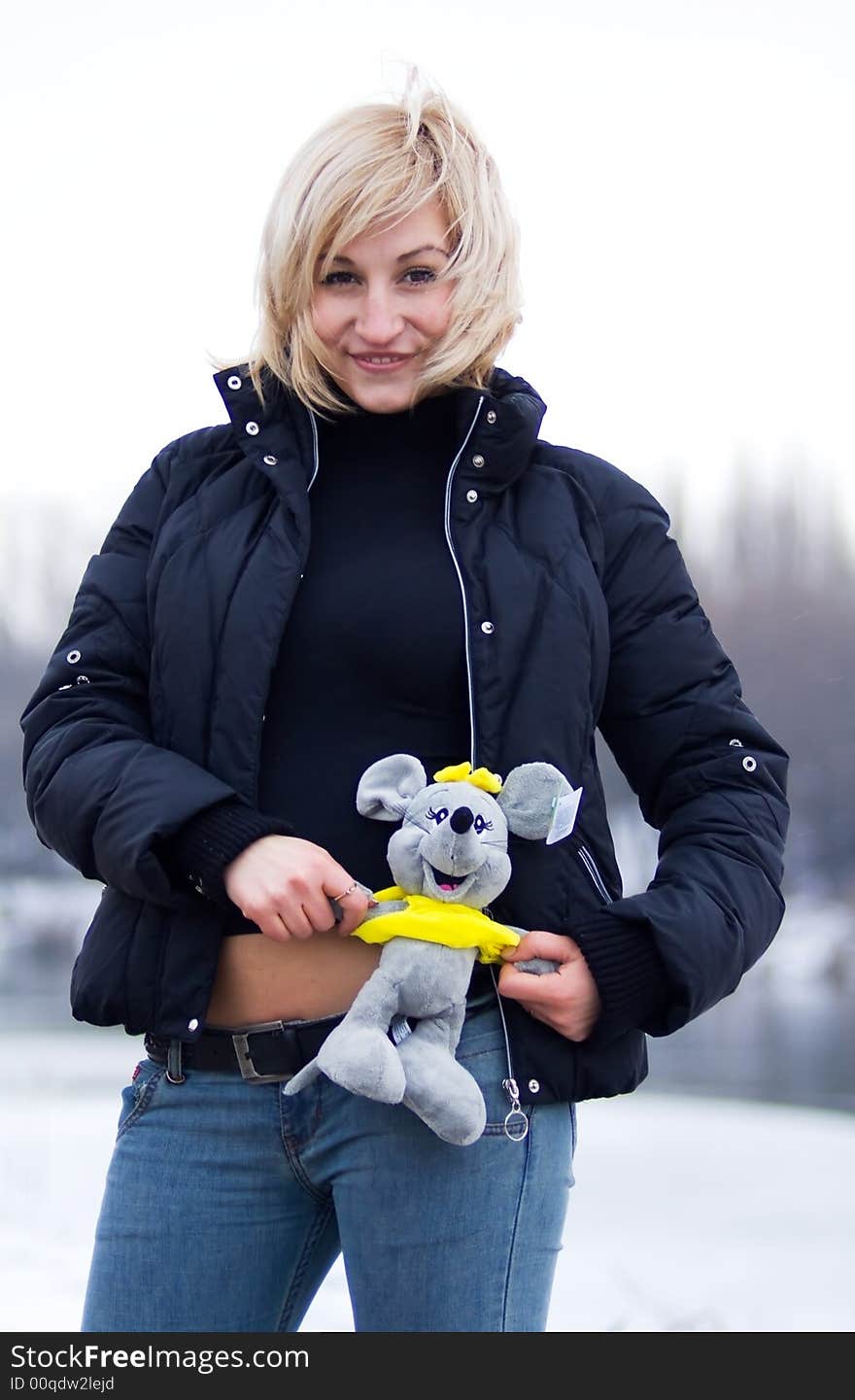 Young blonde woman with toy rat