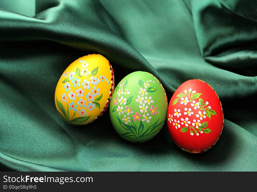 Easter Eggs on Green Satin Fabric