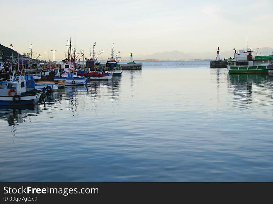 Fisher boats in small harbor at dawn. Fisher boats in small harbor at dawn