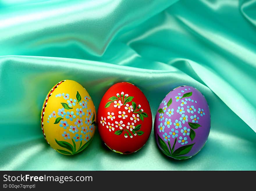 Easter Eggs on Turquoise Satin Fabric