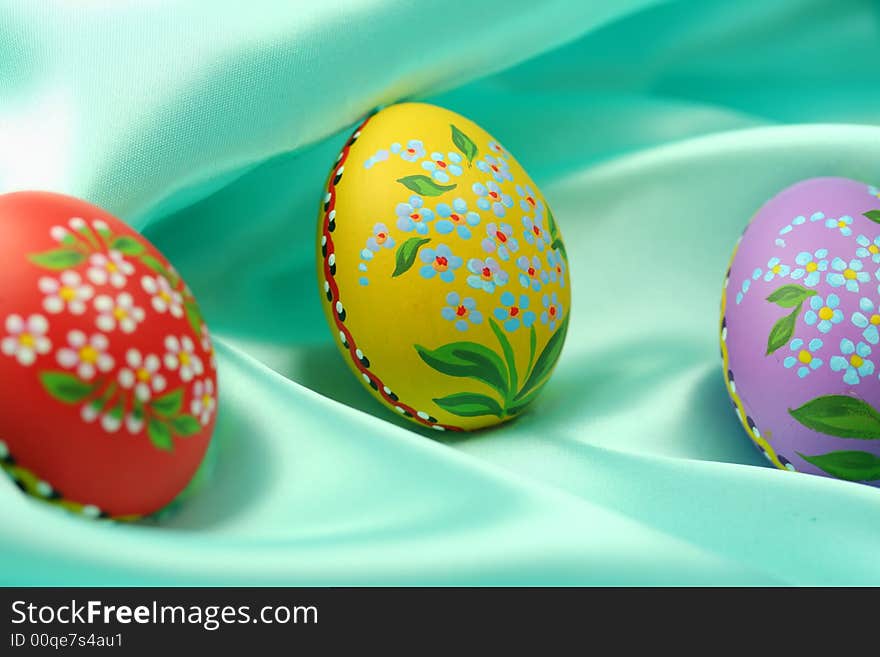 Easter Eggs on Turquoise Satin Fabric