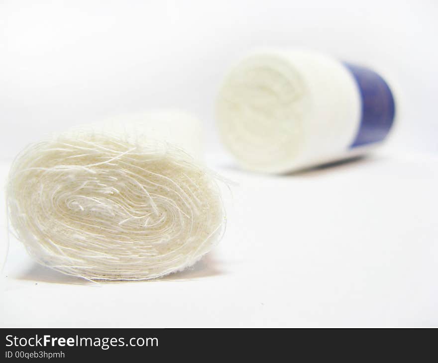 Bandage with bottle on white background